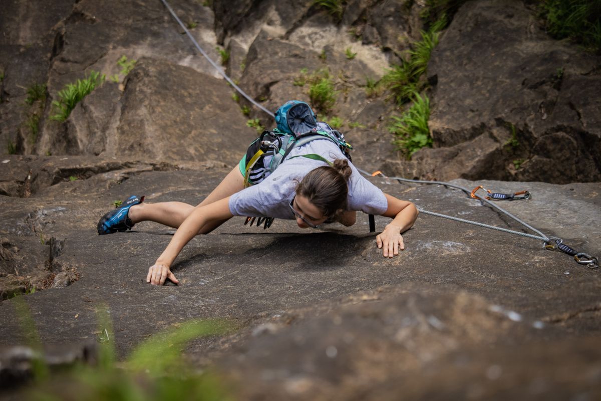 Climber stretched across a granite slab