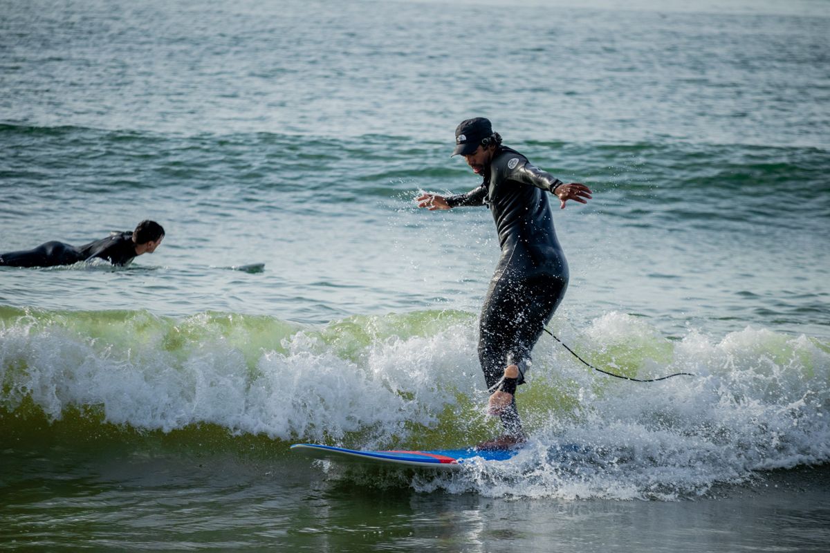 Surfer riding a small green wave